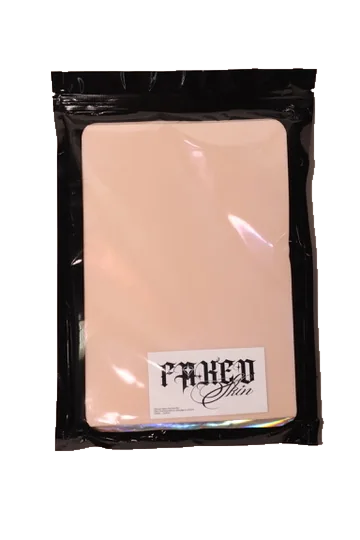 Faked Skin practice pad in its labelled black resealable package, front view